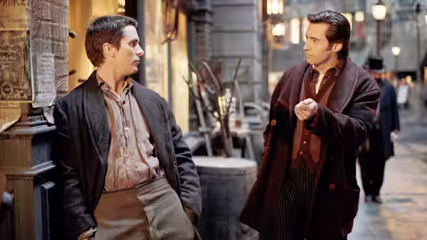 Alfred Borden (Christian Bale) facing Robert Angier (Hugh Jackman) on a nighttime street