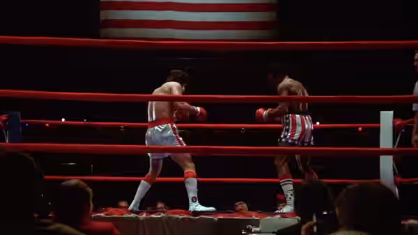 Rocky Balboa (Sylvester Stallone) and Apollo Creed (Carl Weathers) box in the ring