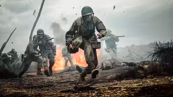 Soldiers charging forward across muddy ground amid explosions and smoke