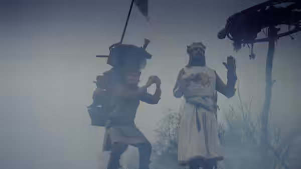 King Arthur gestures beside his laden servant in foggy woods