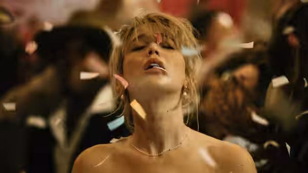 Grace (Jennifer Lawrence) with head tilted back amid falling confetti