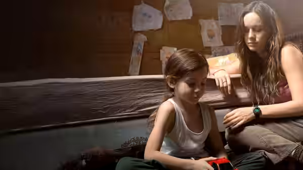 Ma (Brie Larson) watching Jack (Jacob Tremblay) play with a toy truck