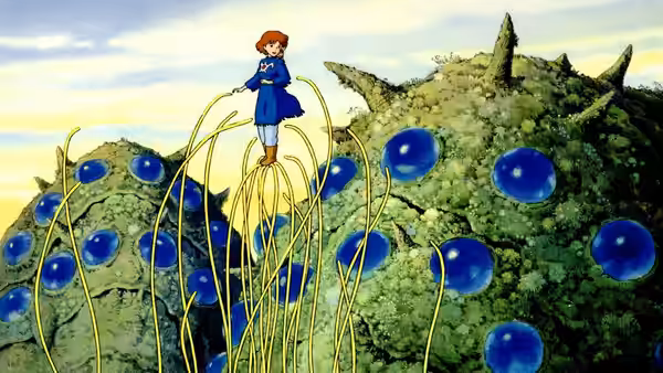 Nausicaä (Sumi Shimamoto) atop a giant creature covered in blue orbs