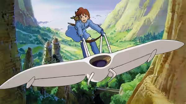 Nausicaä (Sumi Shimamoto) steering her glider above a green valley