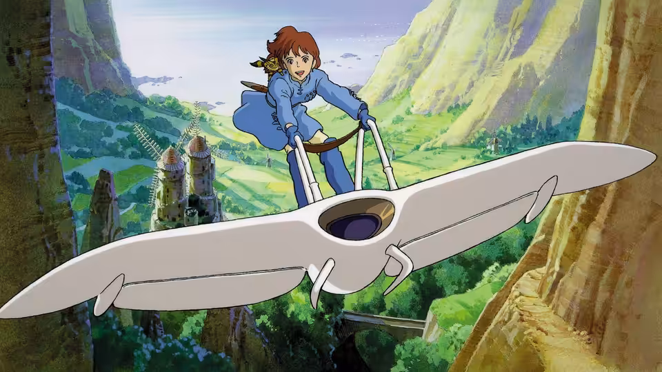 Nausicaä (Sumi Shimamoto) steering her glider above a green valley