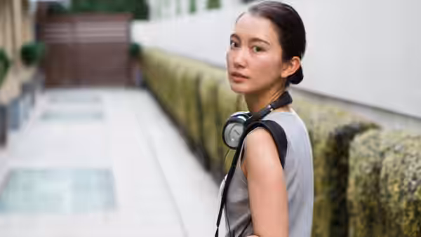 Shiori Itō looks back along a quiet outdoor walkway