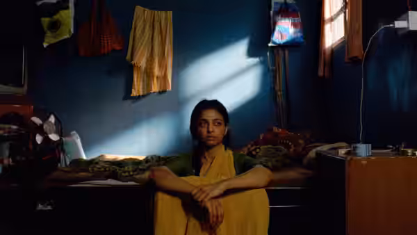 Uma (Radhika Apte) sits on the floor of a sparsely furnished room