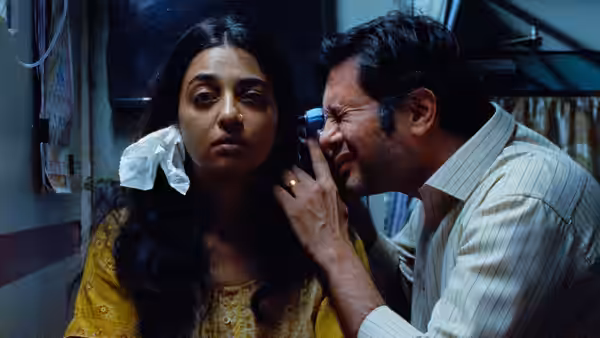 Gopal (Ashok Pathak) leans close to Uma, touching her face inside a train