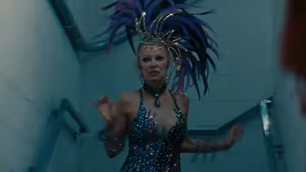 Shelly (Pamela Anderson) in a sequined showgirl costume moves through a backstage corridor
