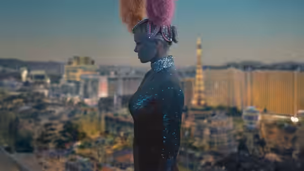 Shelly (Pamela Anderson) in a feathered showgirl headdress looks out over Las Vegas