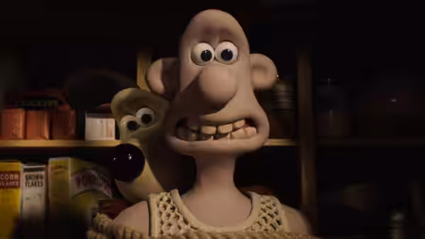 Wallace peers anxiously from a pantry while Gromit hides behind him