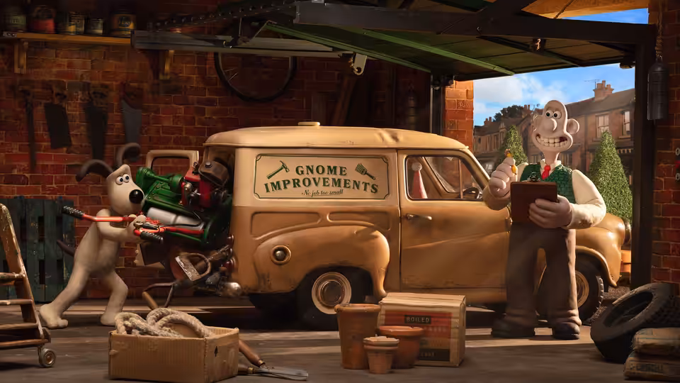 Wallace stands beside the Gnome Improvements van while Gromit loads garden tools in the workshop