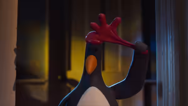 Feathers McGraw raises a red rubber glove beside a doorway