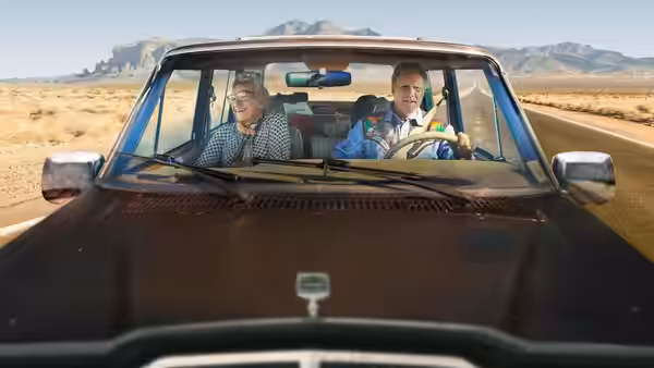 Harper Steele rides beside Will Ferrell as he drives across the desert