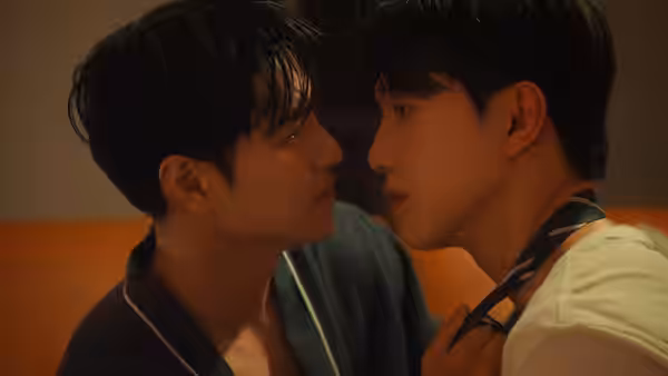 A man in a dark shirt grips another man's loosened tie as they face each other