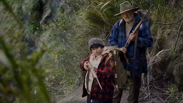 Hec (Sam Neill) and Ricky (Julian Dennison) walking along a forest path