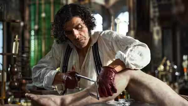 Victor Frankenstein (Oscar Isaac) operating on a leg in his laboratory