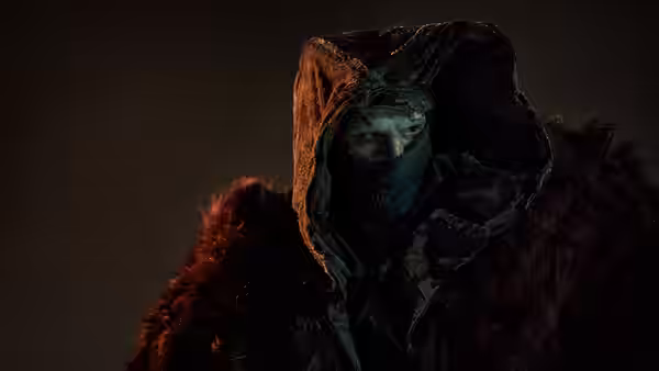 The Creature (Jacob Elordi) in a hooded cloak and mask