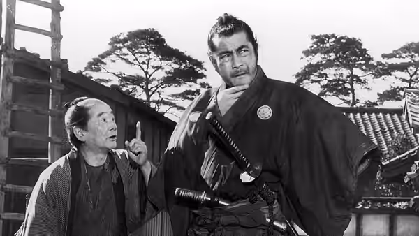 Samurai stands beside an older woman pointing upward outside a village house