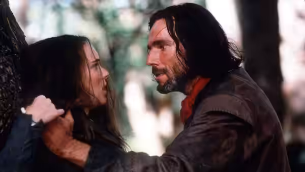 John Proctor (Daniel Day-Lewis) grips Abigail Williams (Winona Ryder) by the shoulders in the woods