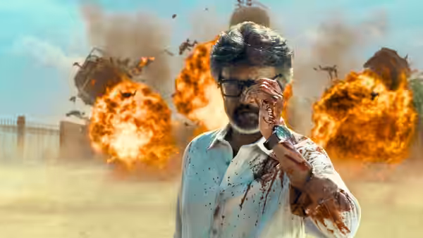 Muthuvel 'Tiger' Pandian (Rajinikanth) adjusts his glasses as explosions erupt behind him