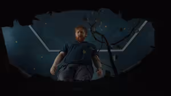 Jon (Rupert Grint) peers down into a dark pit beneath a geometric ceiling