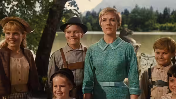 Maria and the von Trapp children stand together by a lake