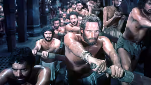 Judah Ben-Hur (Charlton Heston) pulls an oar with other galley slaves