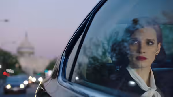 Madeline Sloane (Jessica Chastain) looks out a car window as the Capitol recedes behind her
