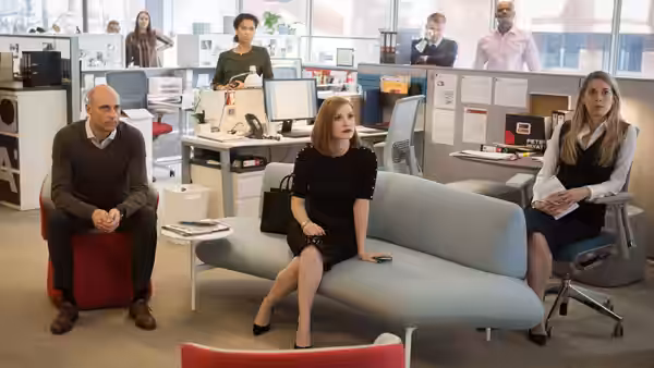 Madeline Sloane (Jessica Chastain) sits among colleagues in a bright office lounge