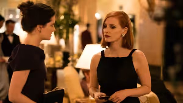 Madeline Sloane (Jessica Chastain) talks with a woman at an elegant reception