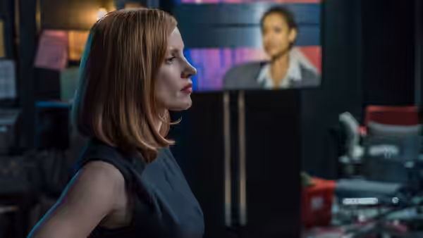 Madeline Sloane (Jessica Chastain) watches a televised speaker from a control room
