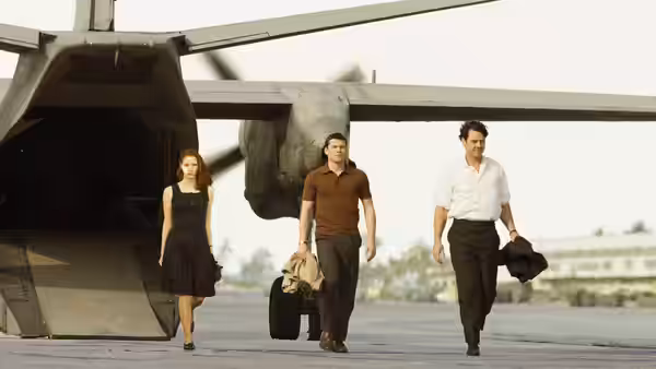 Young Rachel Singer, Young Stefan Gold, and Young David Peretz walk away from a transport plane carrying luggage