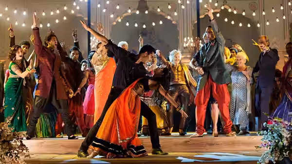 Guests dance beneath strings of lights at a lively celebration