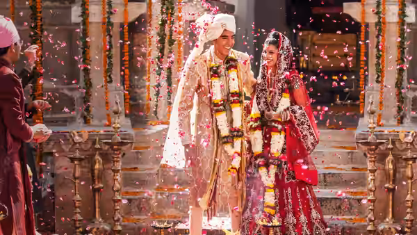 Sonny Kapoor (Dev Patel) and Sunaina (Tina Desai) stand together in wedding attire