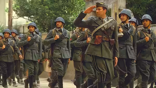 Captain Antonio Corelli (Nicolas Cage) salutes as Italian soldiers gather around him in a village street