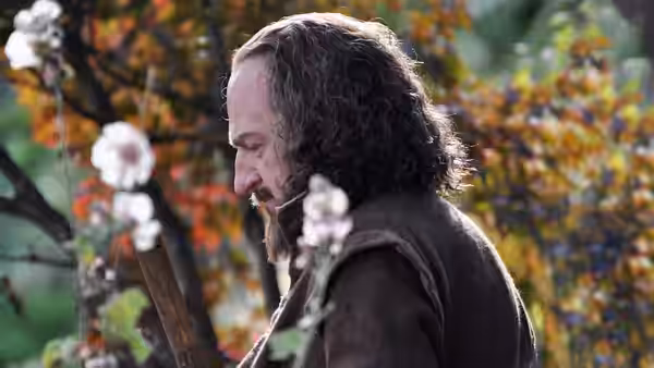 William Shakespeare (Kenneth Branagh) tends plants in a garden
