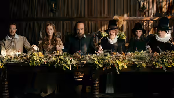 William Shakespeare (Kenneth Branagh) and family sit at a flower-covered table
