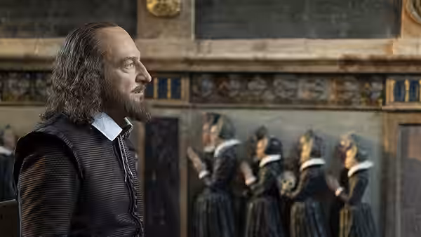 William Shakespeare (Kenneth Branagh) stands in profile before women gathered in a hall
