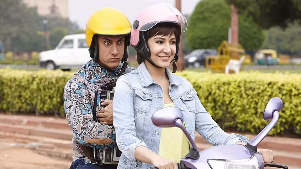 Anushka Sharma as Jaggu riding a scooter with Aamir Khan as PK