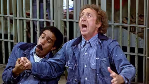 Harry Monroe (Richard Pryor) and Skip Donahue (Gene Wilder) react in alarm inside a barred prison cell