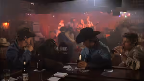 Philo Beddoe (Clint Eastwood) sits with an orangutan and companions at a crowded bar