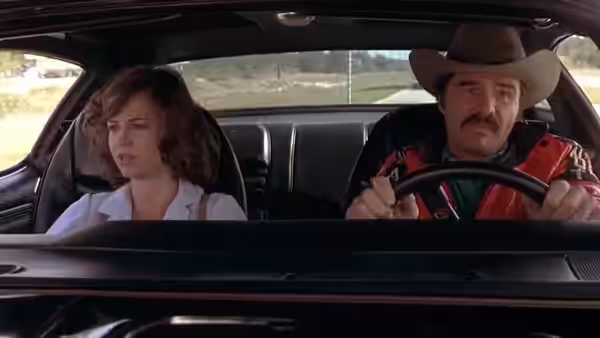 Carrie (Sally Field) rides beside Bandit (Burt Reynolds) as he drives
