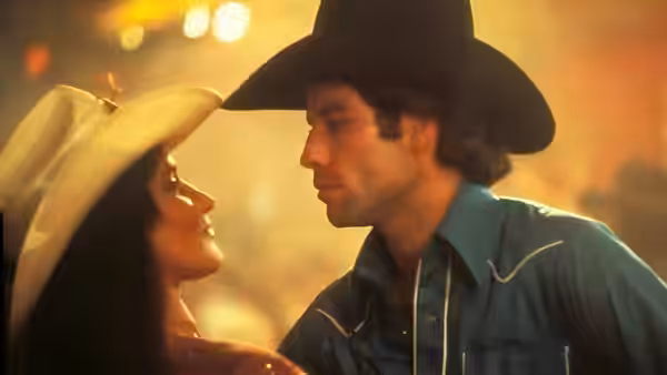 Bud Davis (John Travolta) leans close to Sissy (Debra Winger) in the dance hall