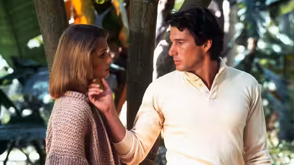 Julian Kaye (Richard Gere) touches Michelle Stratton’s (Lauren Hutton) chin among trees
