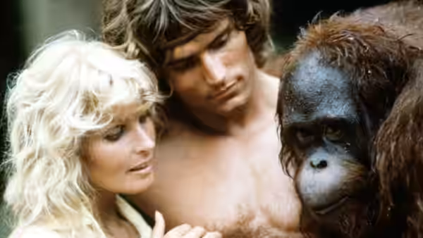 Jane (Bo Derek) and Tarzan (Miles O'Keeffe) stand beside a gorilla