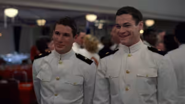 Zack Mayo and Sid Worley smile together in dress uniforms at a gathering