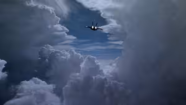 A jet flies through a break in towering clouds