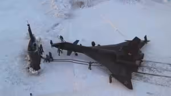 Ground crew gather beside a Soviet fighter jet on a snow-covered runway