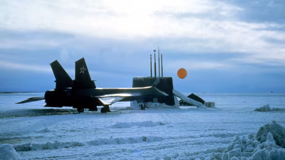 A Soviet fighter jet rests on an icy runway beneath a low Arctic sun
